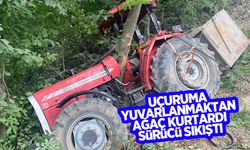 Uçuruma kaydı ağaçla traktör arasında sıkıştı
