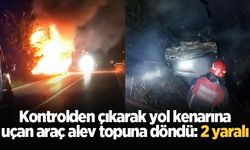 Kontrolden çıkarak yol kenarına uçan araç alev topuna döndü: 2 yaralı