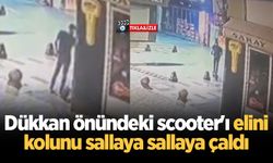 Dükkan önündeki scooter'ı elini kolunu sallaya sallaya çaldı
