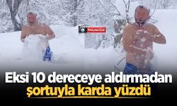 Eksi 10 dereceye aldırmadan şortuyla karda yüzdü