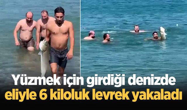 Yüzmek için girdiği denizde eliyle 6 kiloluk levrek yakaladı