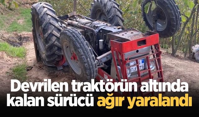 Devrilen traktörün altında kalan sürücü ağır yaralandı