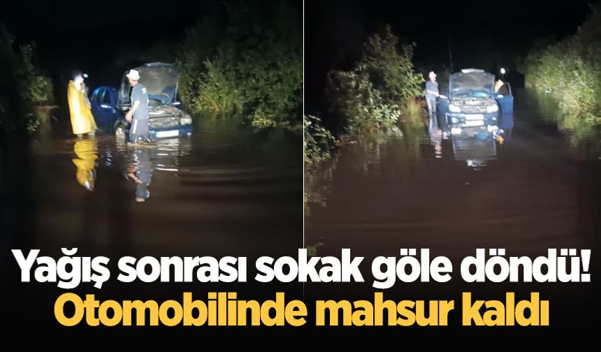 Yağış sonrası sokak göle döndü! Otomobilinde mahsur kaldı