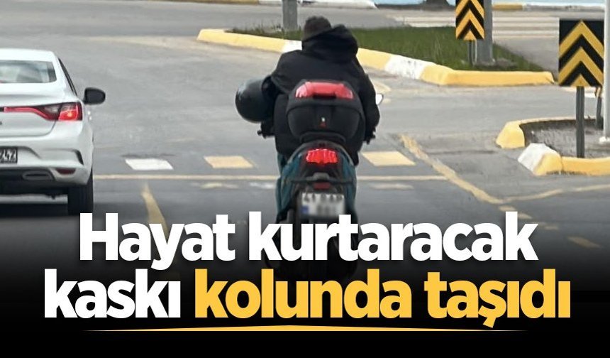 Hayat kurtaracak kaskı kolunda taşıdı